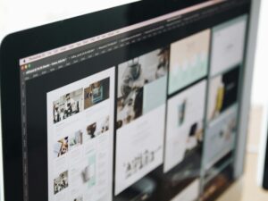 A modern computer screen displaying web design work, showcasing creative visuals in a workspace.
