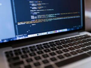 Focused view of programming code displayed on a laptop, ideal for tech and coding themes.